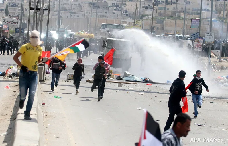 Palestinians protest as they mark the anniversary of Land Day in Qalandia which lies between Jerusalem and the West Bank city of Ramallah on March 30, 2012. Land Day marks the annual event that commemorates the deaths of...