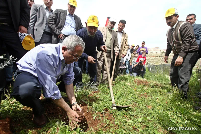 Palestinian Prime Minister, Salam Fayyad, participates during the cultivation of olive trees on the occasion of "Land Day", in the West Bank city of Bethlehem, on Mar. 31, 2012. Photo by Mustafa Abu Dayah