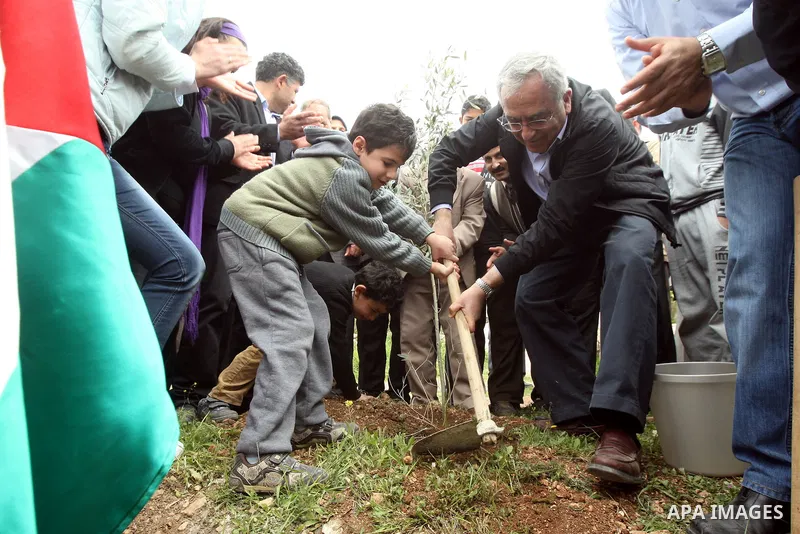 Palestinian Prime Minister, Salam Fayyad, participates during the cultivation of olive trees on the occasion of "Land Day", in the West Bank city of Bethlehem, on Mar. 31, 2012. Photo by Mustafa Abu Dayah
