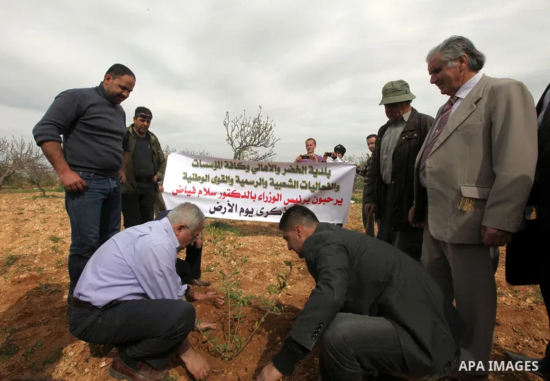 Palestinian Prime Minister, Salam Fayyad, participates during the cultivation of olive trees on the occasion of "Land Day", in the West Bank city of Bethlehem, on Mar. 31, 2012. Photo by Mustafa Abu Dayah