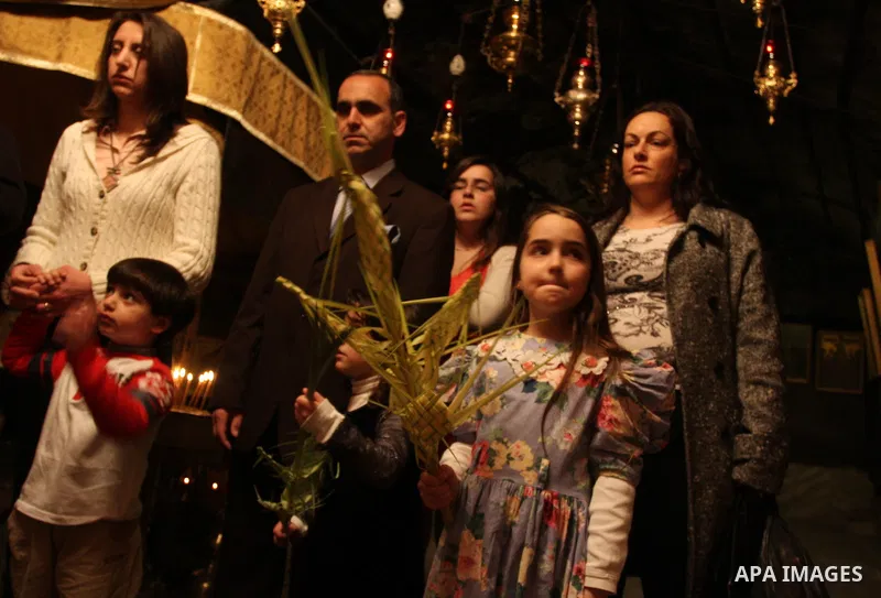 Palestinians Catholic attend a Palm Sunday at a church "Nativity" in Bethlehem in the West Bank in, Sunday, April 1, 2012. Palm Sunday commemorates Jesus Christ's triumphant entry into Jerusalem when his followers laid p...