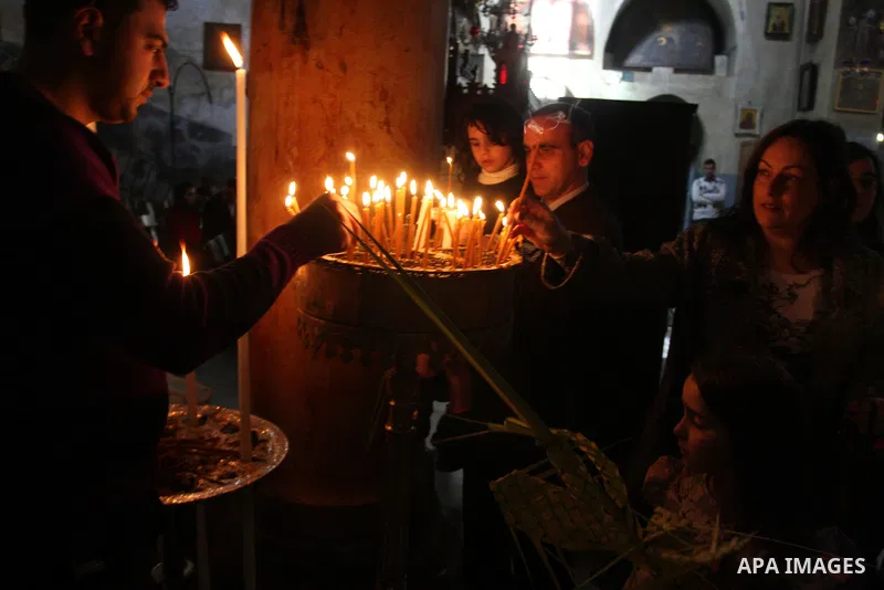 Palestinians Catholic attend a Palm Sunday at a church "Nativity" in Bethlehem in the West Bank in, Sunday, April 1, 2012. Palm Sunday commemorates Jesus Christ's triumphant entry into Jerusalem when his followers laid p...