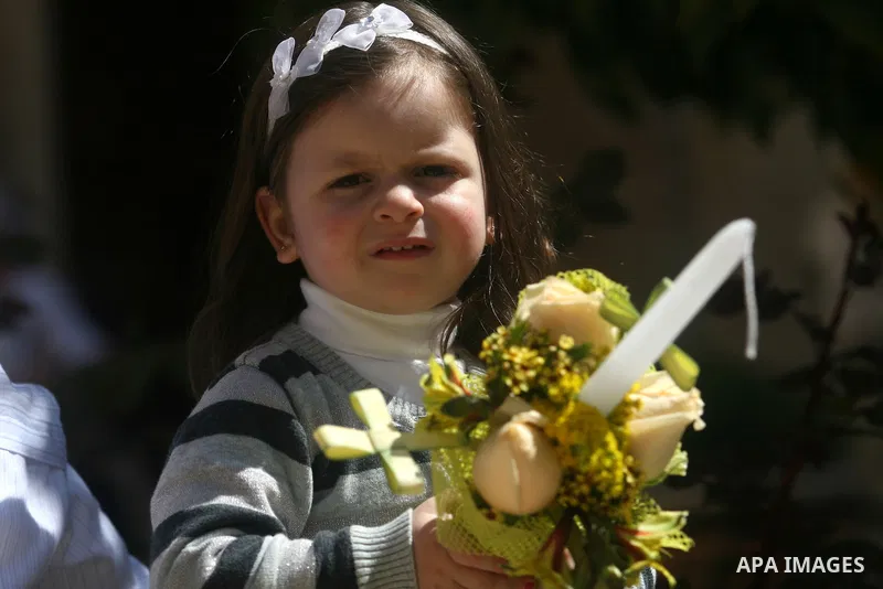 Palestinians Catholic attend a Palm Sunday at a church "Nativity" in Bethlehem in the West Bank in, Sunday, April 1, 2012. Palm Sunday commemorates Jesus Christ's triumphant entry into Jerusalem when his followers laid p...