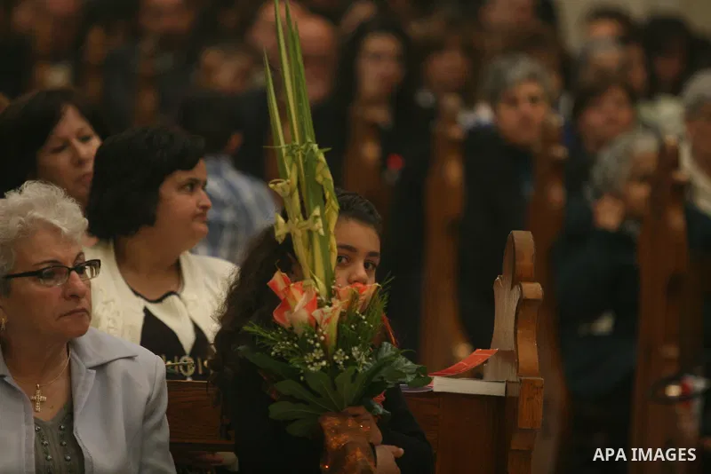 Palestinians Catholic attend a Palm Sunday at a church "Nativity" in Bethlehem in the West Bank in, Sunday, April 1, 2012. Palm Sunday commemorates Jesus Christ's triumphant entry into Jerusalem when his followers laid p...