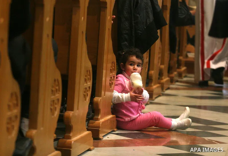 Palestinians Catholic attend a Palm Sunday at a church "Nativity" in Bethlehem in the West Bank in, Sunday, April 1, 2012. Palm Sunday commemorates Jesus Christ's triumphant entry into Jerusalem when his followers laid p...