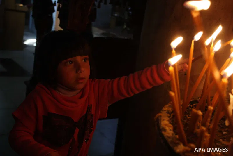 Palestinians Catholic attend a Palm Sunday at a church "Nativity" in Bethlehem in the West Bank in, Sunday, April 1, 2012. Palm Sunday commemorates Jesus Christ's triumphant entry into Jerusalem when his followers laid p...