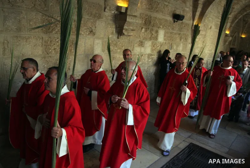 Palestinians Catholic attend a Palm Sunday at a church "Nativity" in Bethlehem in the West Bank in, Sunday, April 1, 2012. Palm Sunday commemorates Jesus Christ's triumphant entry into Jerusalem when his followers laid p...