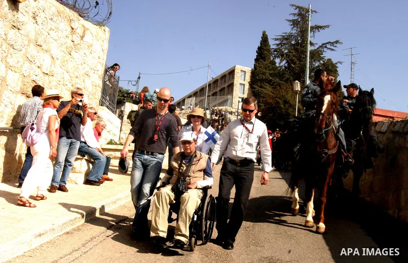 Christian pilgrims march during the traditional Palm Sunday procession from the Mount of Olives to Jerusalem's old city on April 1, 2012. Photo by Mahfouz Abu Turk