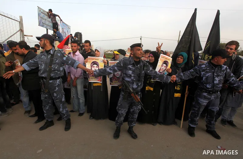 Palestinians hold posters of Hanaa Shalabi, a prisoner who spent 43 days on hunger strike, as they wait to greet her near the Erez border crossing between Israel and the northern Gaza Strip on April 1, 2012. Shalabi, who...