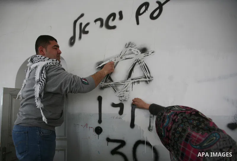 Israeli soldiers enter an abandoned house on April 01, 2012, where Palestinian protesters and foreign activists took refuge and fly Palestinian flags on the building near the Beit Romano area that several hundred Jewish...