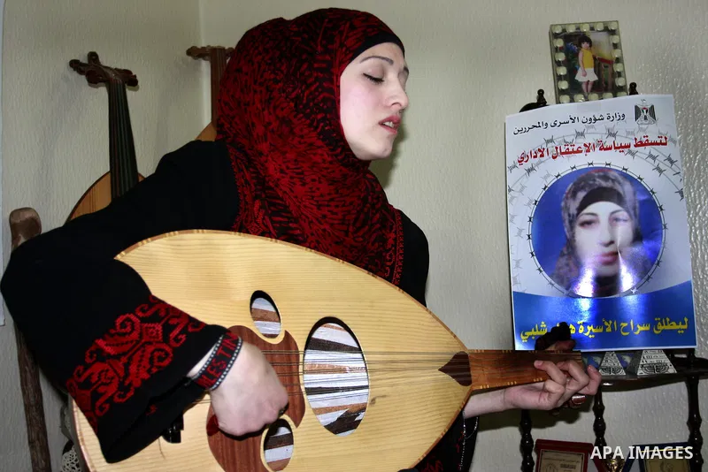 Palestinian Walaa Dwikat sings and plays a musical instrument " Al oud" supporting the palestinian prisoner Hanaa Shalabi in the West Bank of Balata , on Apr. 01, 2012. Photo by Wagdi Eshtayah