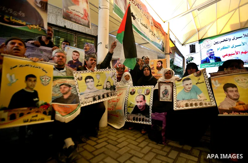 Palestinian relatives prisoners attend a protest calling for the release of their sons held in Israeli jails next the International Red Cross in Gaza City, Gaza Strip, on Apr. 02, 2012. Photo by Ali Jadallah