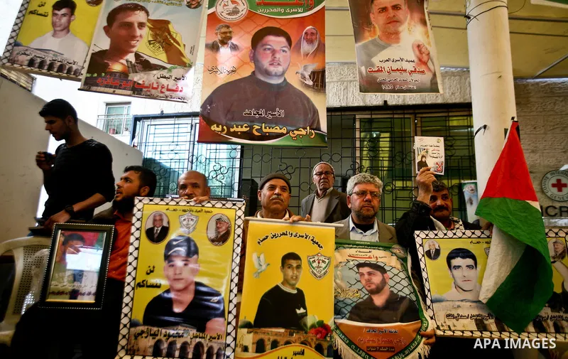 Palestinian relatives prisoners attend a protest calling for the release of their sons held in Israeli jails next the International Red Cross in Gaza City, Gaza Strip, on Apr. 02, 2012. Photo by Ali Jadallah