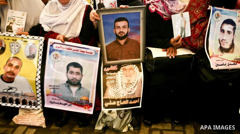 Palestinian relatives prisoners attend a protest calling for the release of their sons held in Israeli jails next the International Red Cross in Gaza City, Gaza Strip, on Apr. 02, 2012. Photo by Ali Jadallah