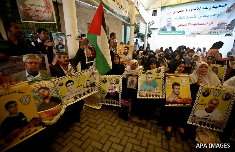Palestinian relatives prisoners attend a protest calling for the release of their sons held in Israeli jails next the International Red Cross in Gaza City, Gaza Strip, on Apr. 02, 2012. Photo by Ali Jadallah