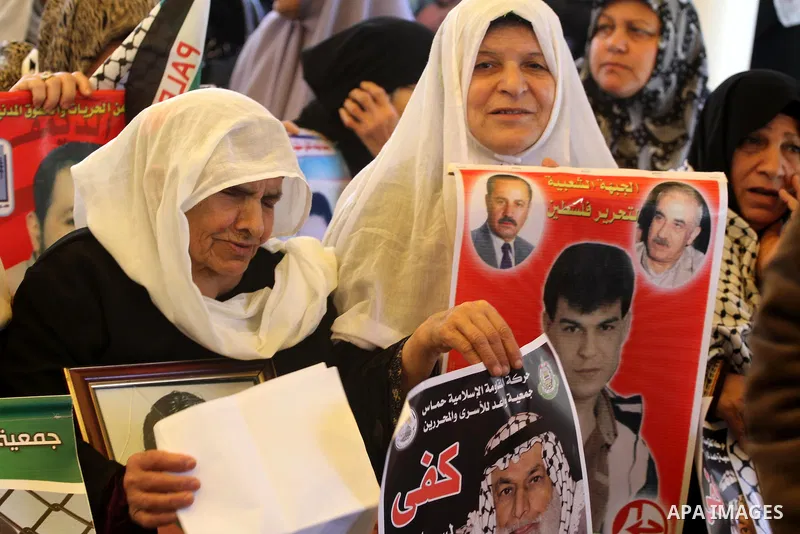 Palestinian relatives prisoners attend a protest calling for the release of their sons held in Israeli jails next the International Red Cross in Gaza City, Gaza Strip, on Apr. 02, 2012. Photo by Mohammed Asad