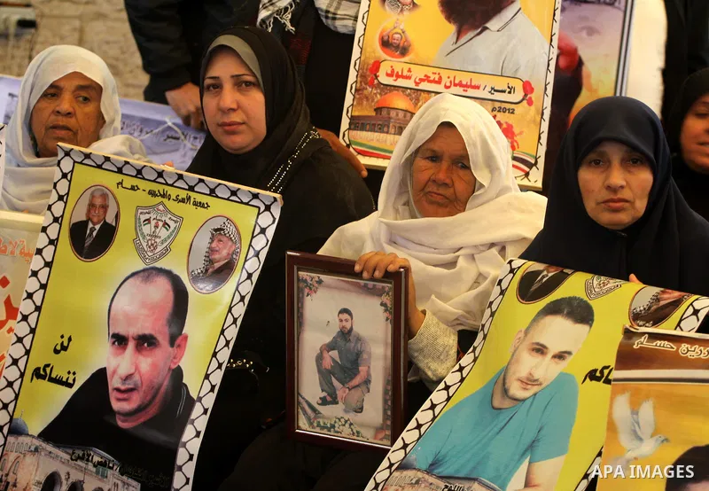 Palestinian relatives prisoners attend a protest calling for the release of their sons held in Israeli jails next the International Red Cross in Gaza City, Gaza Strip, on Apr. 02, 2012. Photo by Mohammed Asad