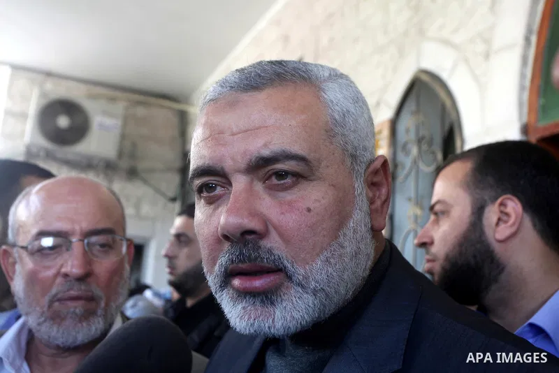 Palestinian prime minister in Gaza Strip, Ismail Haniya participates in the funneral of the three children who were killed in a domestic fire during their funeral during their funeral procession in Deir al-Balah in the c...
