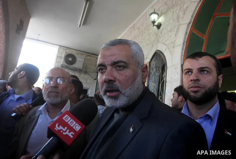 Palestinian prime minister in Gaza Strip, Ismail Haniya participates in the funneral of the three children who were killed in a domestic fire during their funeral during their funeral procession in Deir al-Balah in the c...
