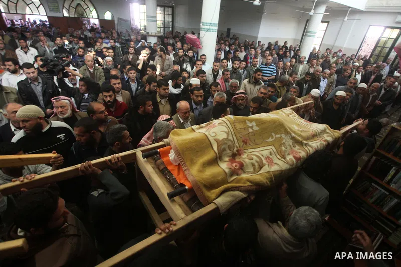 Palestinian mourners carry the bodies of three children who died the previous day in a domestic fire during their funeral in Deir al-Balah in the central Gaza Strip on April 02, 2012. The three Palestinian children, aged...