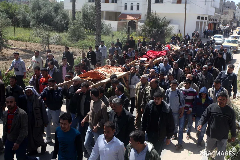 Palestinian mourners carry the bodies of three children who died the previous day in a domestic fire during their funeral in Deir al-Balah in the central Gaza Strip on April 02, 2012. The three Palestinian children, aged...