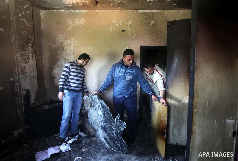 Palestinian men inspect on April 2, 2012 the damage in the bedroom of three children who were killed the previous day in a domestic fire in Deir al-Balah in the central Gaza Strip. The three Palestinian children, aged tw...