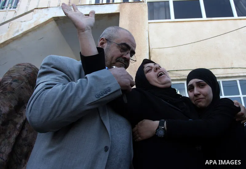 Palestinian women mourn during the funeral on April 2, 2012 in Rammun of Rashad Deeb, who was shot and injured by Israeli troops along with his two brothers in the early hours of March 27 in an incident in the West Bank...
