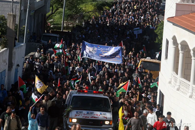 Palestinian mourners carry the body of Rashad Deeb, who was shot and injured by Israeli troops along with his two brothers in the early hours of March 27 in an incident in the West Bank village, 10 kilometres (six miles)...