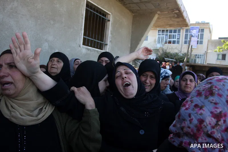 Palestinian women mourn during the funeral on April 2, 2012 in Rammun of Rashad Deeb, who was shot and injured by Israeli troops along with his two brothers in the early hours of March 27 in an incident in the West Bank...