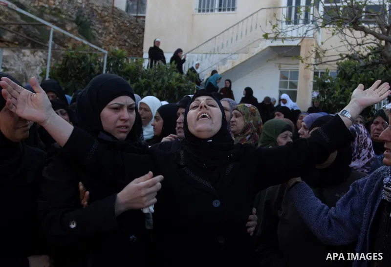 Palestinian women mourn during the funeral on April 2, 2012 in Rammun of Rashad Deeb, who was shot and injured by Israeli troops along with his two brothers in the early hours of March 27 in an incident in the West Bank...