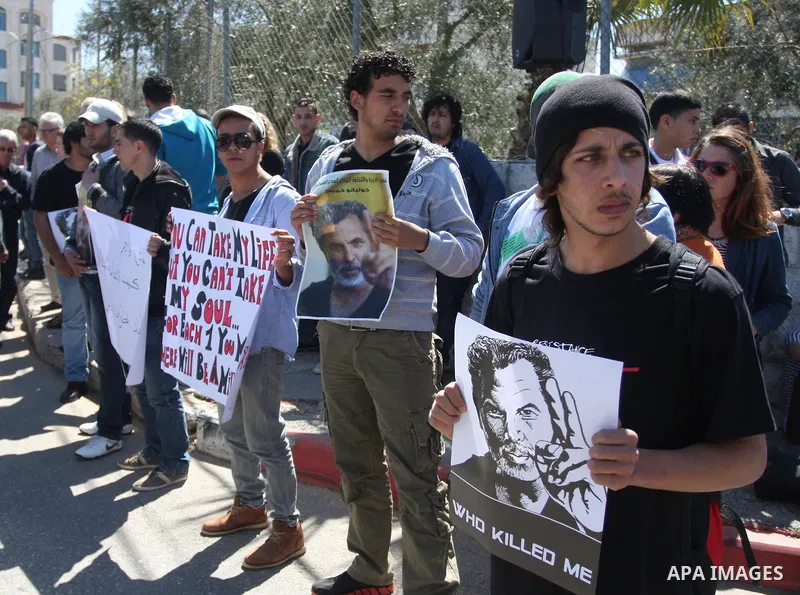 Dozens of Palestinians and foreigners, including artists, demonstrate in the West Bank city of Ramallah on April 4, 2012 to mark one year since the killing of Israeli-Palestinian theatre director Juliano Mer Khamis (port...