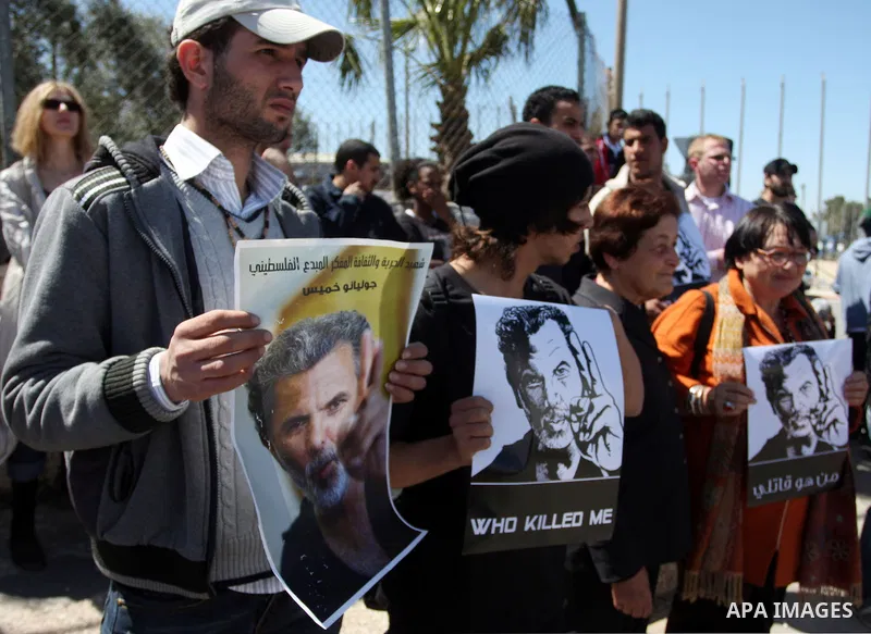 Dozens of Palestinians and foreigners, including artists, demonstrate in the West Bank city of Ramallah on April 4, 2012 to mark one year since the killing of Israeli-Palestinian theatre director Juliano Mer Khamis (port...