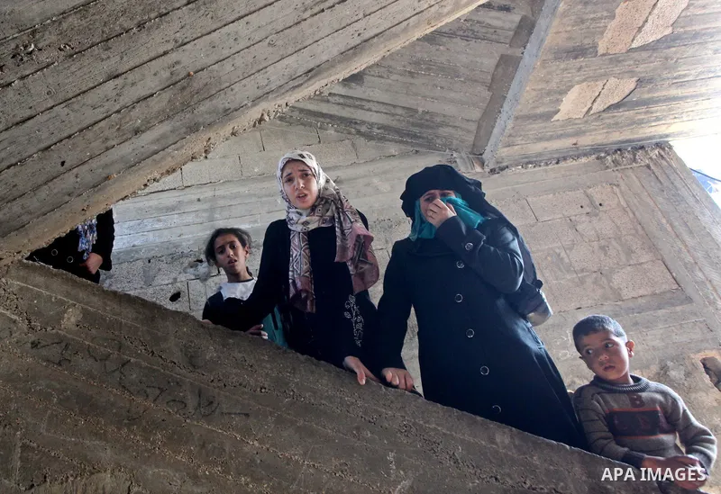 Palestinian women grieve as they watch the body of Palestinian youth Hashem Saed, 17-years-old, leave his home during his funeral in Gaza City on April 4, 2012, after he was shot overnight close along the border fence be...
