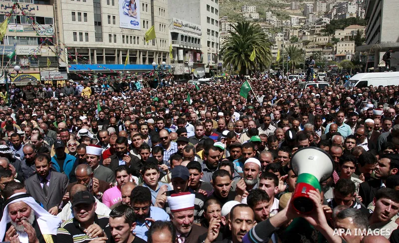 Palestinian mourners gather around the body of Sheikh Hamed Al-Betawi member of the Legislative Council for Hamas during his funeral in the West Bank city of Thursday, April 5, 2012 . Photo by Wagdi Eshtayah