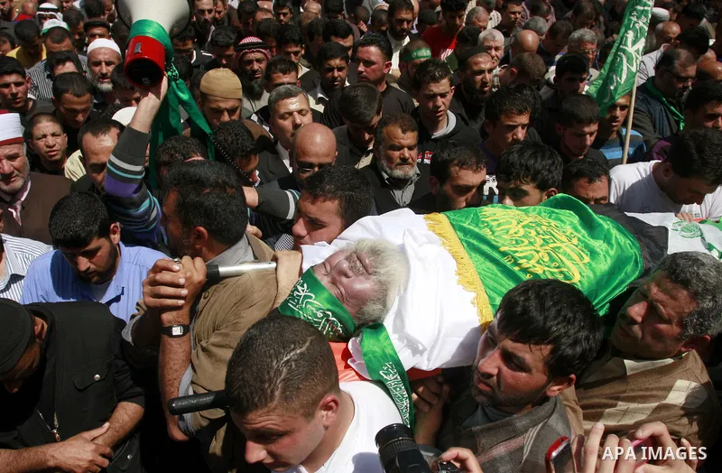 Palestinian mourners gather around the body of Sheikh Hamed Al-Betawi member of the Legislative Council for Hamas during his funeral in the West Bank city of Thursday, April 5, 2012 . Photo by Wagdi Eshtayah