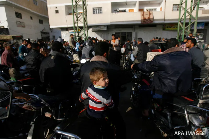 Palestinians wait to fill fuel containers from a petrol station in Rafah in the southern Gaza Strip, 05 April 2012. Reports state that residents in the Gaza Strip flocked to petrol stations hoping to get a share of the r...
