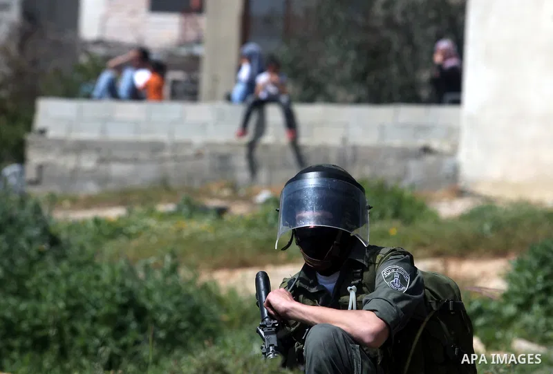Israeli soldiers stand guard during clashes with palestinian who protest against Palestinian land confiscation to expand the Jewish Hallamish settlement in the West Bank village of Nabi Saleh, near Ramallah, on April 6,...
