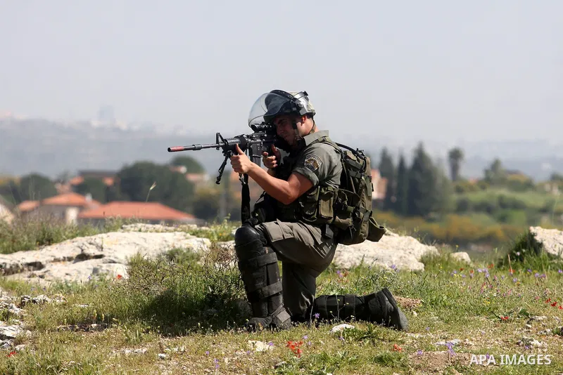 Israeli soldiers stand guard during clashes with palestinian who protest against Palestinian land confiscation to expand the Jewish Hallamish settlement in the West Bank village of Nabi Saleh, near Ramallah, on April 6,...