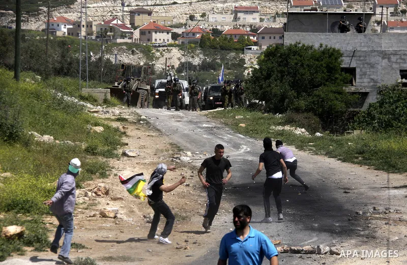 Palestinian protesters confront Israeli troops during a demonstration in the village Kafr Qaddum, close to the northern town of Nablus in the occupied Israeli West Bank on April 06, 2012. Photo by Wagdi Eshtayah