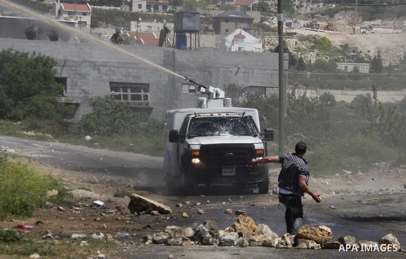 Palestinian protesters confront Israeli troops during a demonstration in the village Kafr Qaddum, close to the northern town of Nablus in the occupied Israeli West Bank on April 06, 2012. Photo by Wagdi Eshtayah