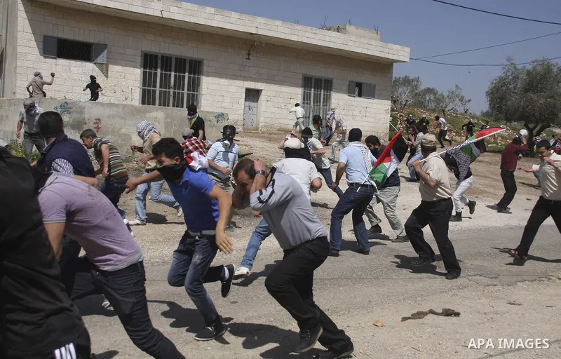Palestinian protesters confront Israeli troops during a demonstration in the village Kafr Qaddum, close to the northern town of Nablus in the occupied Israeli West Bank on April 06, 2012. Photo by Wagdi Eshtayah