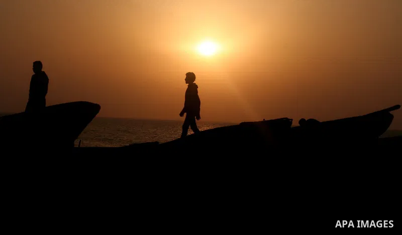 Palestinian fishermen are seen silhouetted on their boat in the Mediterranean sea during sunset to the West of Gaza city, 06 April 2012. Photo by Emad Nassar