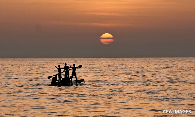 Palestinian fishermen are seen silhouetted on their boat in the Mediterranean sea during sunset to the West of Gaza city, 06 April 2012. Photo by Ali Jadallah