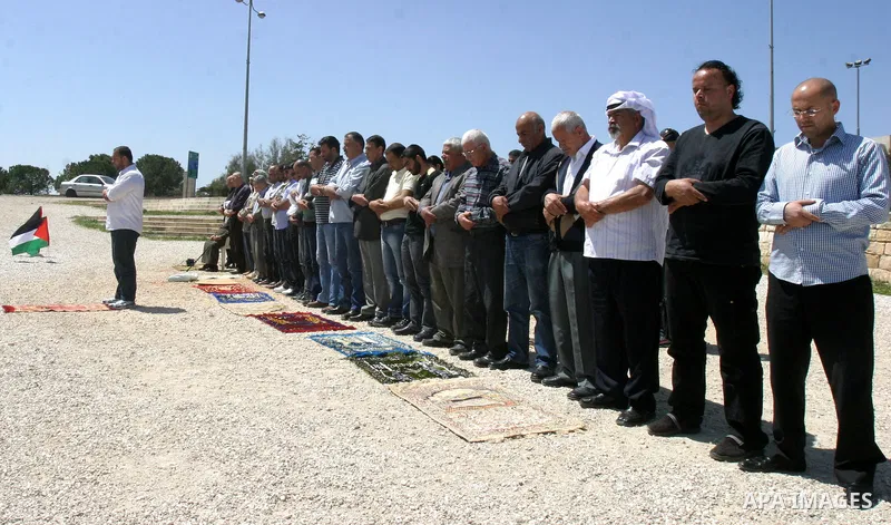Palestinians pray on a street during Friday noon prayers on Apr. 06, 2012 in the East Jerusalem. Photo by Mahfouz Abu Turk