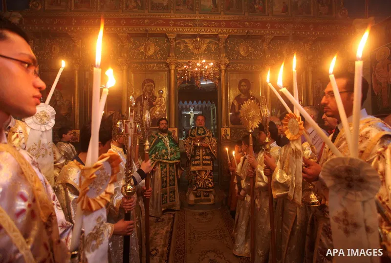 An Orthodox priest leads a Palm Sunday mass at the Saint Porfirios church in Gaza City April 8, 2012. Photo by Ashraf Amra
