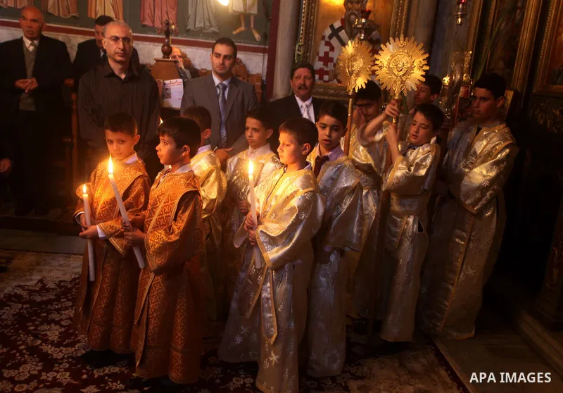 Palestinian Christian Catholics attend an Easter Vigil mass in Gaza City on April 8, 2012. Christians around the world mark the Holy Week of Easter to commemorate the crucifixion and resurrection of Jesus Christ. Photo b...