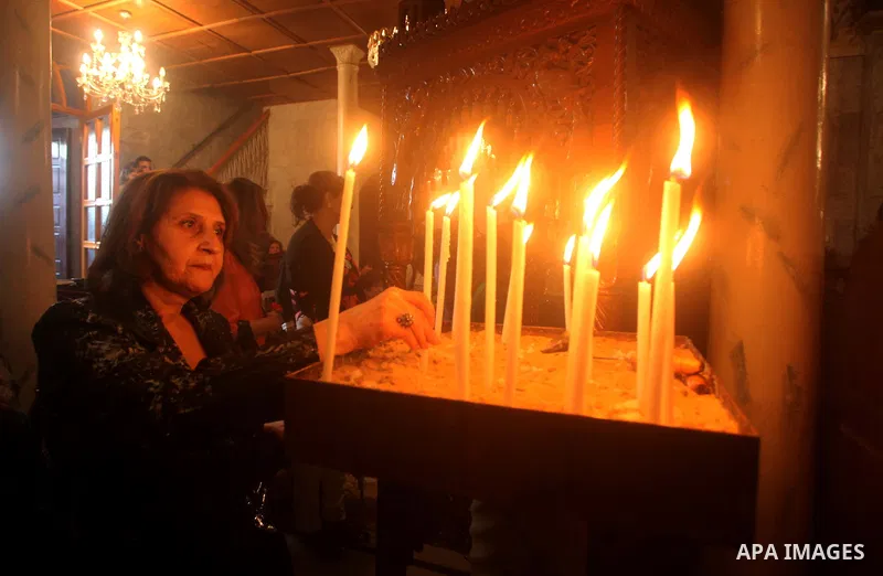 Palestinian Christian Catholics attend an Easter Vigil mass in Gaza City on April 8, 2012. Christians around the world mark the Holy Week of Easter to commemorate the crucifixion and resurrection of Jesus Christ. Photo b...