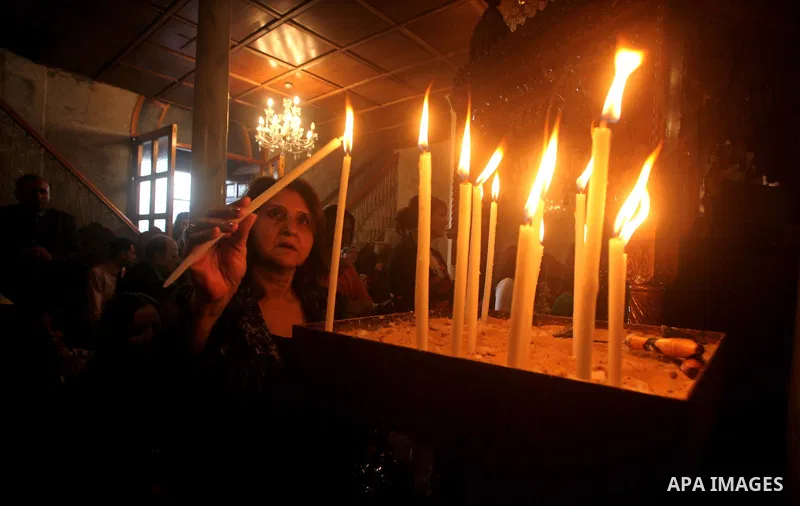 Palestinian Christian Catholics attend an Easter Vigil mass in Gaza City on April 8, 2012. Christians around the world mark the Holy Week of Easter to commemorate the crucifixion and resurrection of Jesus Christ. Photo b...