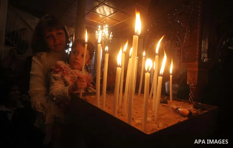 Palestinian Christian Catholics attend an Easter Vigil mass in Gaza City on April 8, 2012. Christians around the world mark the Holy Week of Easter to commemorate the crucifixion and resurrection of Jesus Christ. Photo b...