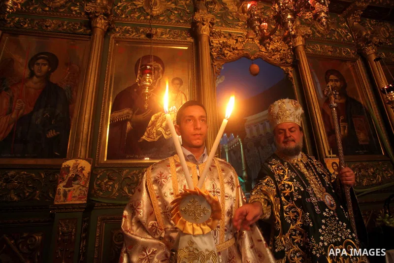 An Orthodox priest leads a Palm Sunday mass at the Saint Porfirios church in Gaza City April 8, 2012. Photo by Ashraf Amra